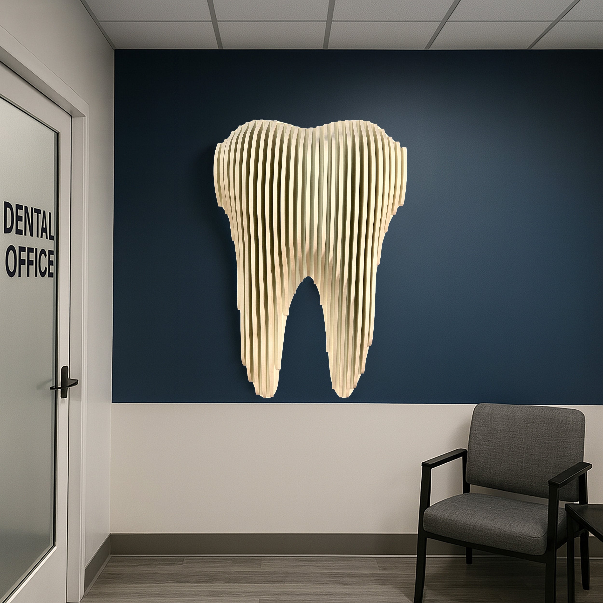 Dental office interior with a large tooth sculpture on the wall.